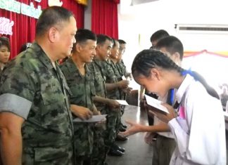 High ranking officials from the Marine Corps Savings Cooperative distribute scholarships to children of the Marine Corp.